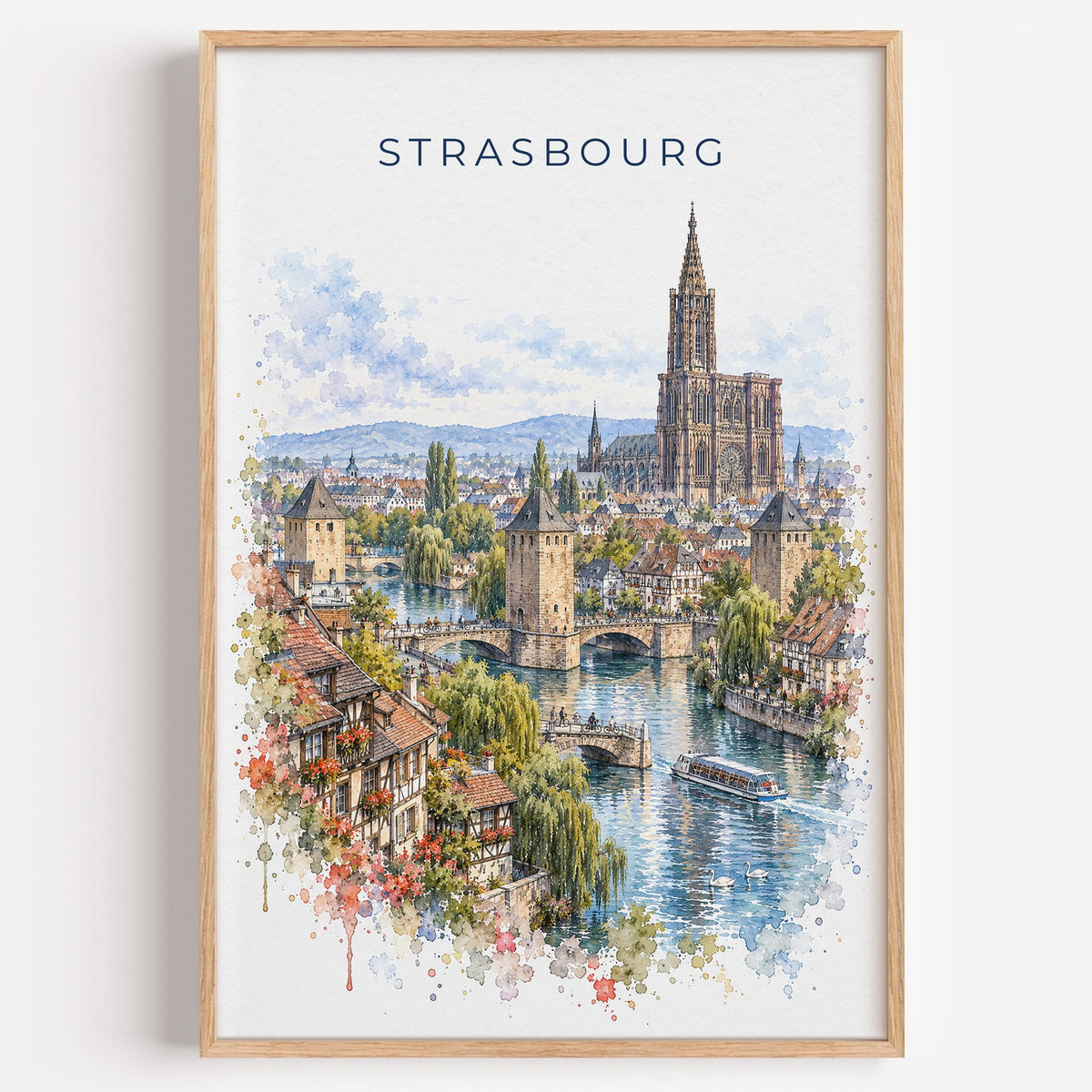 Strasbourg watercolor print in a light oak frame on a plain white wall