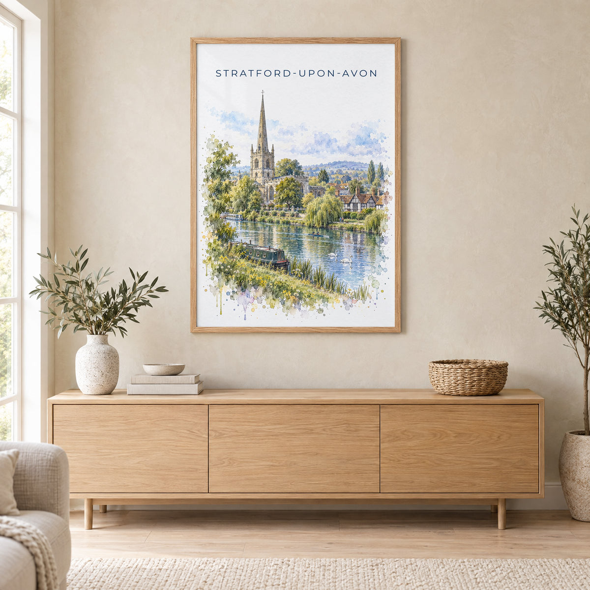 Stratford-upon-Avon watercolor print in an oak frame above a light wood sideboard in a Scandinavian living room