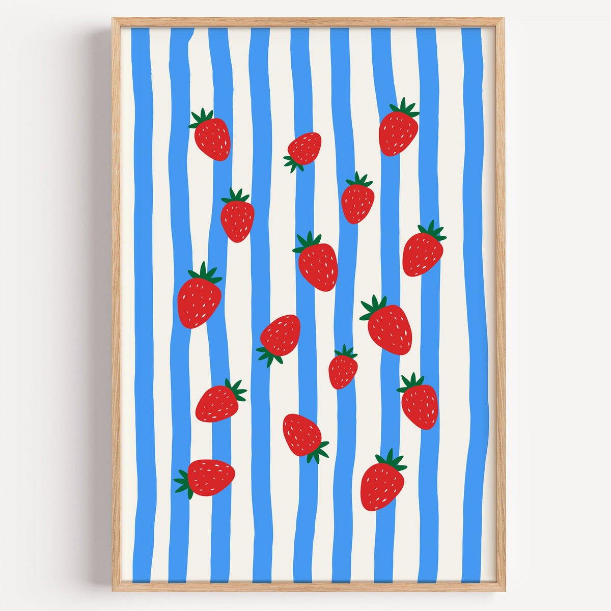 Strawberries blue stripe print in a light oak frame on a plain white wall