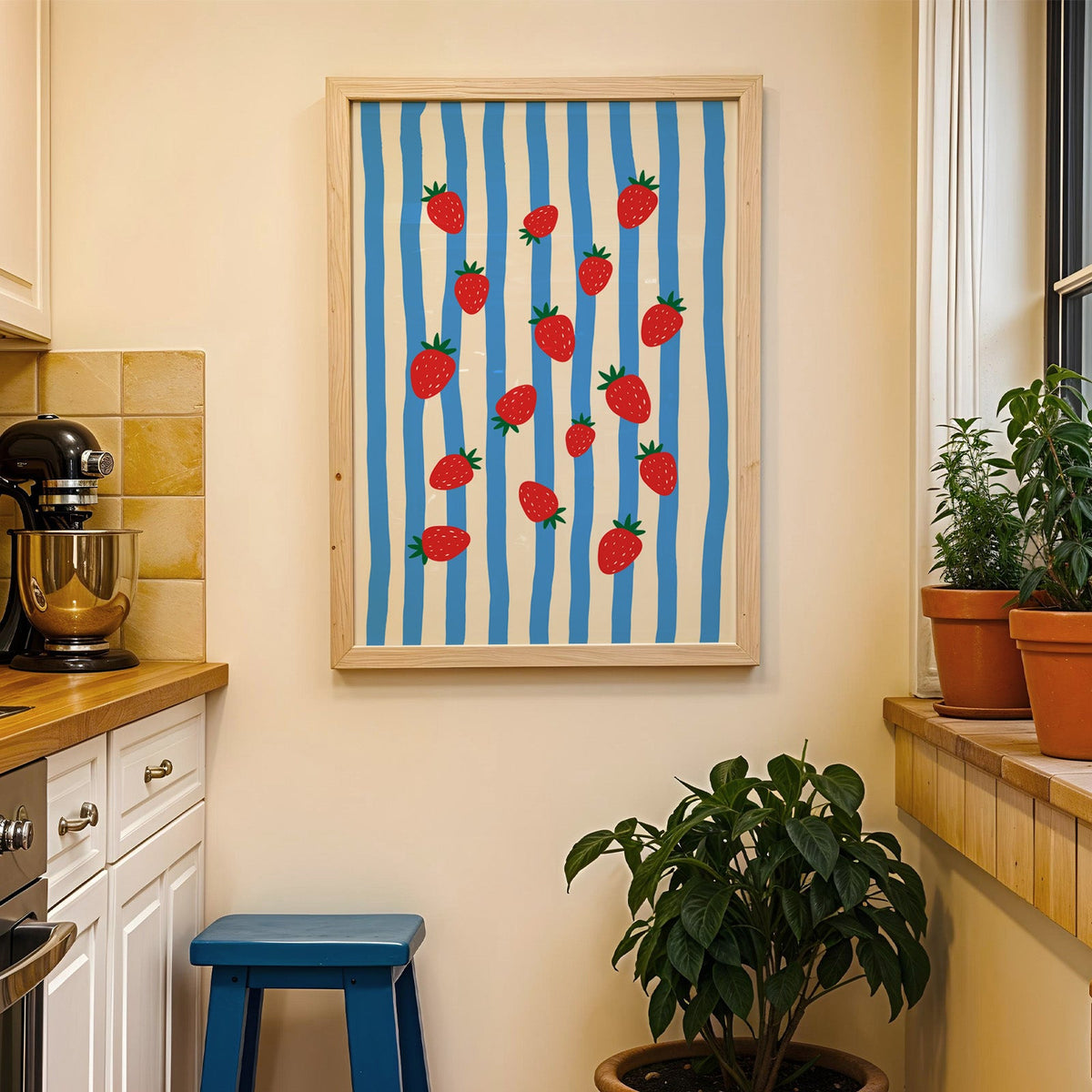 Strawberries blue stripe print in a wood frame on a yellow tiled kitchen wall