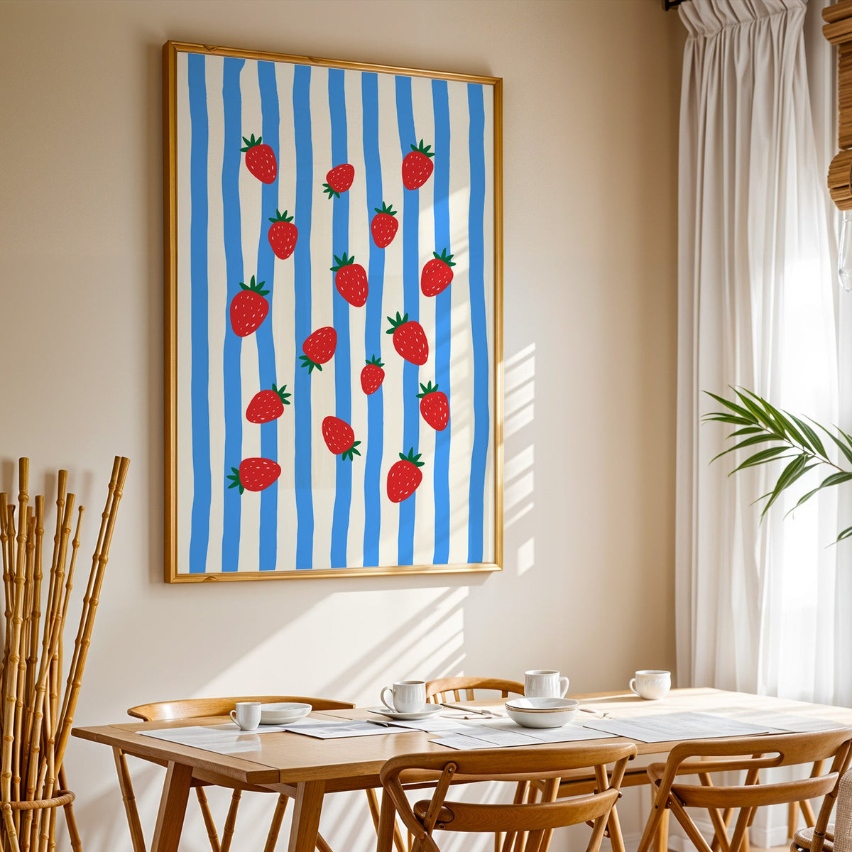 Strawberries blue stripe print in a gold frame above a sunlit breakfast table