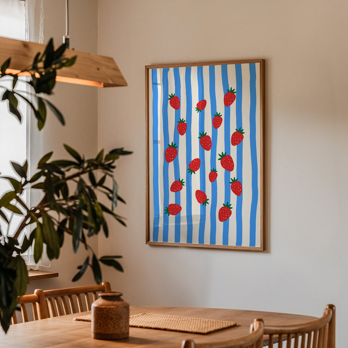 Strawberries blue stripe print in a walnut frame above a table beside an olive tree