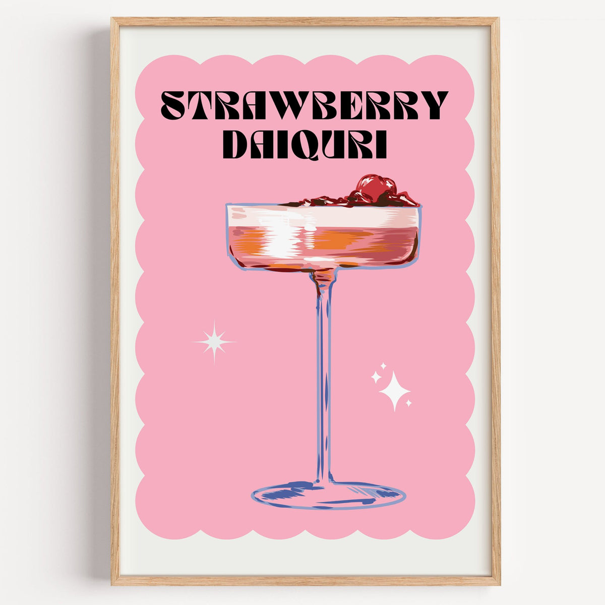Strawberry daiquiri pink coupe print in a light oak frame on a plain white wall