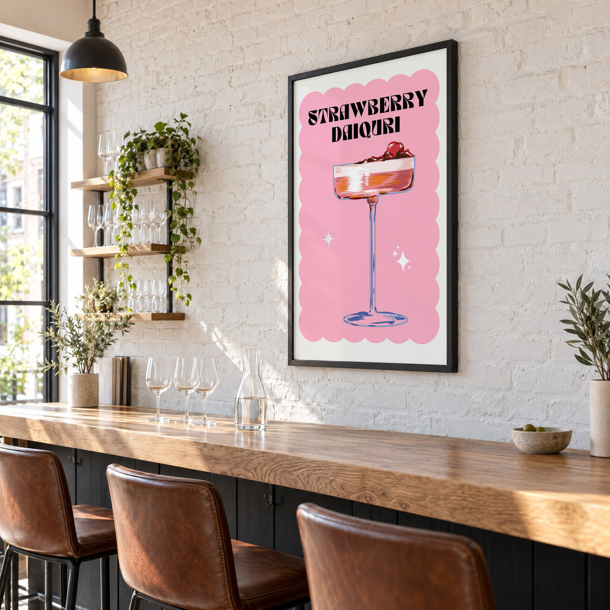 Strawberry daiquiri pink coupe print in a black frame on a white brick wall above a wine bar counter