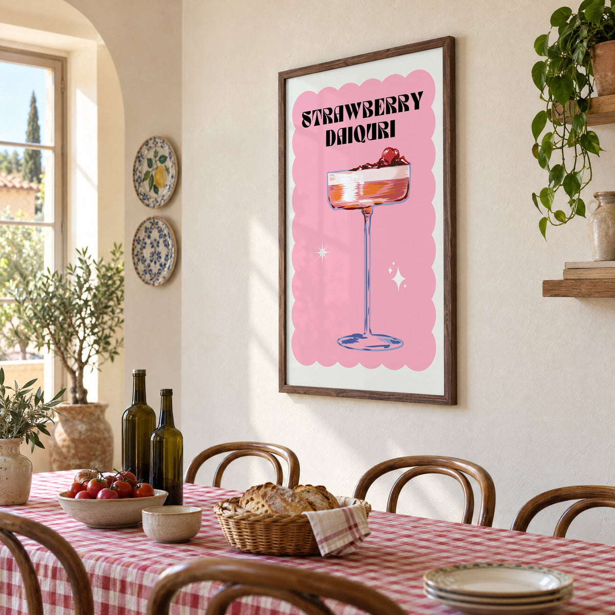 Strawberry daiquiri pink coupe print in a walnut frame above a gingham-covered trattoria table, seen at an angle