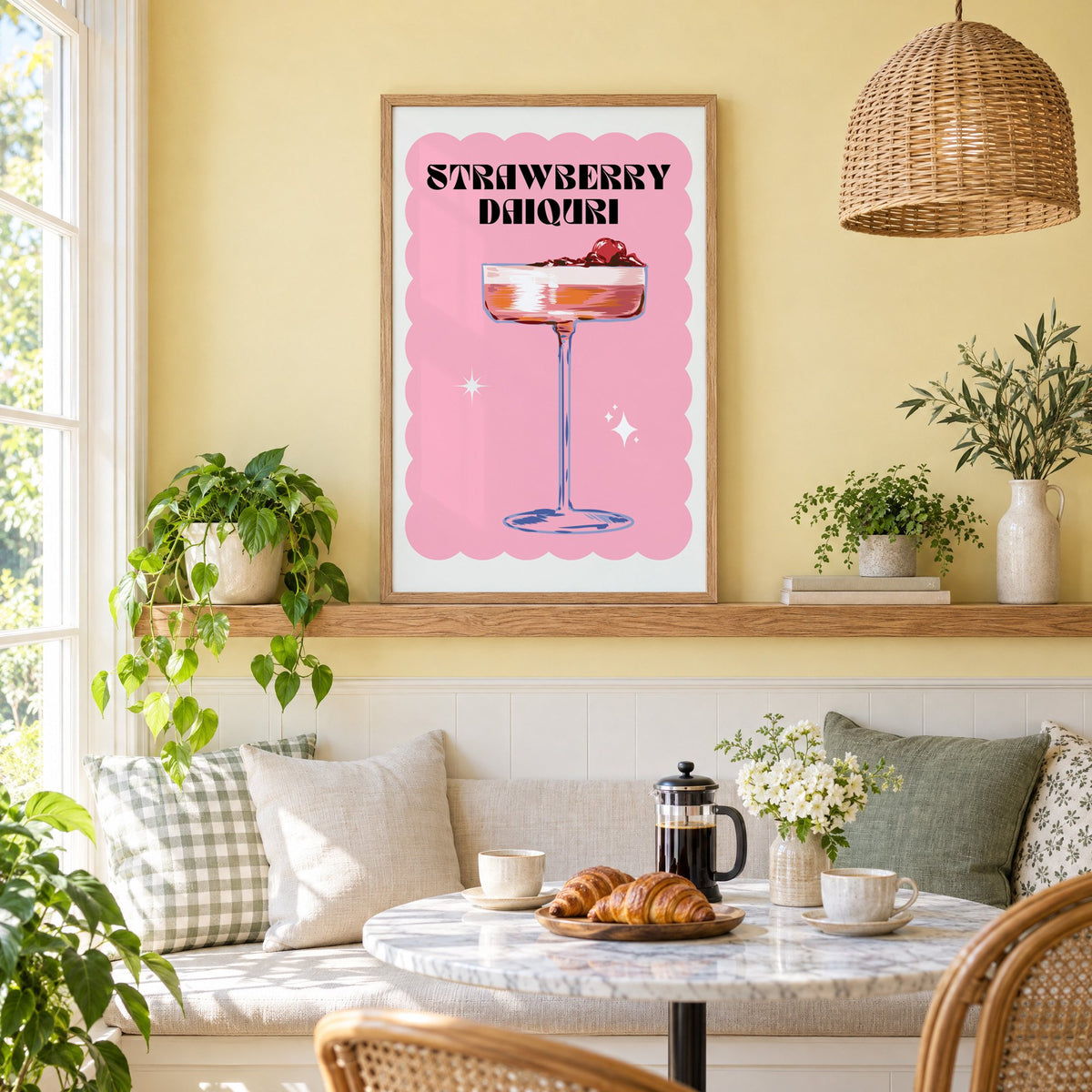 Strawberry daiquiri pink coupe print in an oak frame on a picture ledge above a sunny breakfast nook