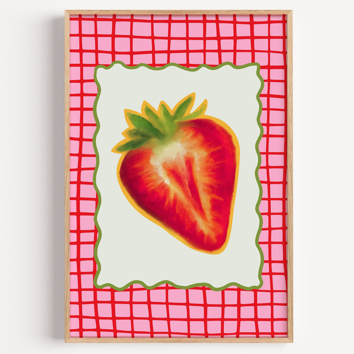 Strawberry red grid print in a light oak frame on a plain white wall