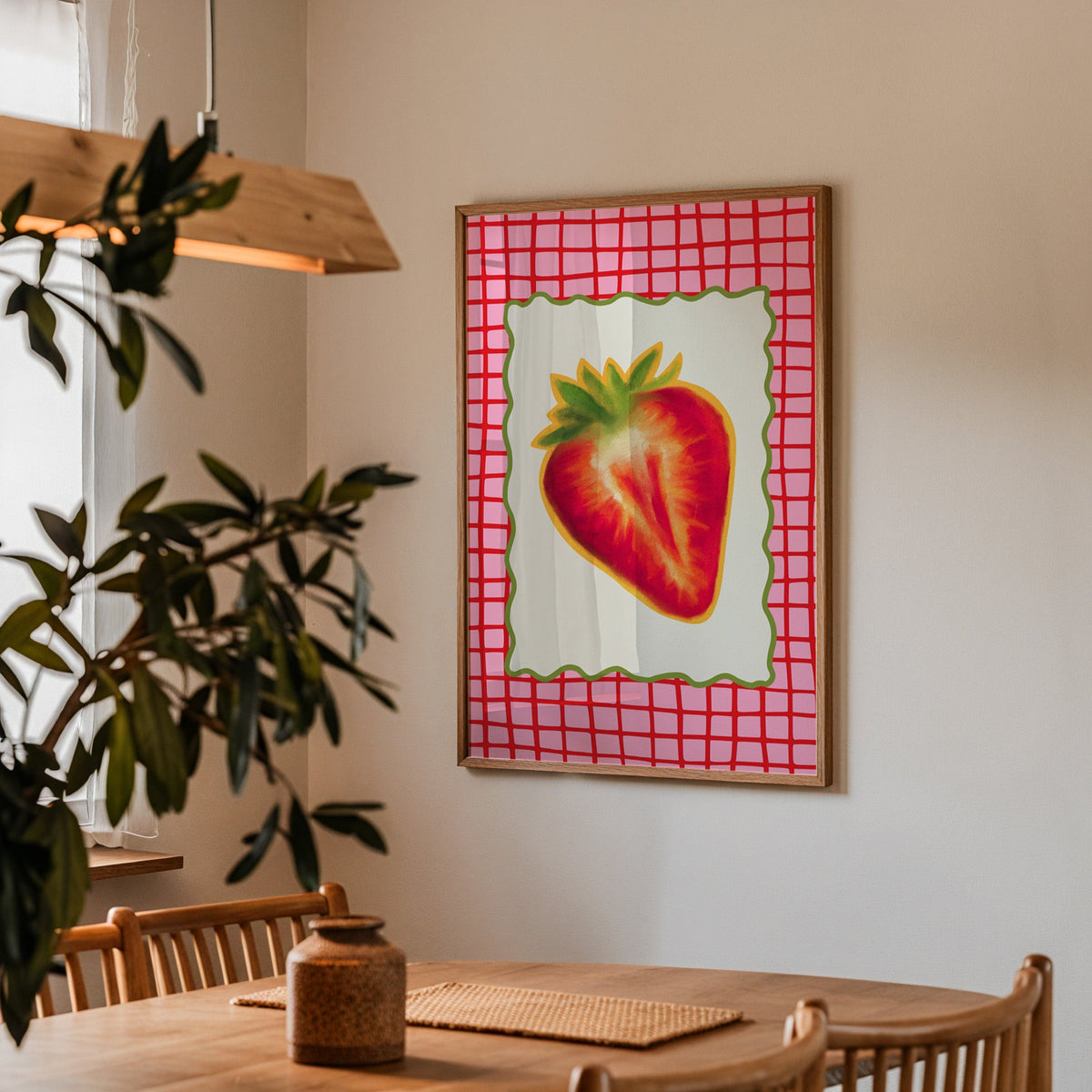 Strawberry red grid print in a walnut frame above a dining table with olive branches