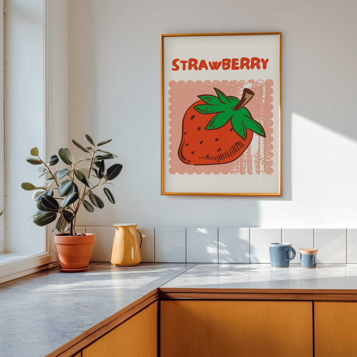 Strawberry scallop print shown in a gold frame above a marble counter in a tan kitchen