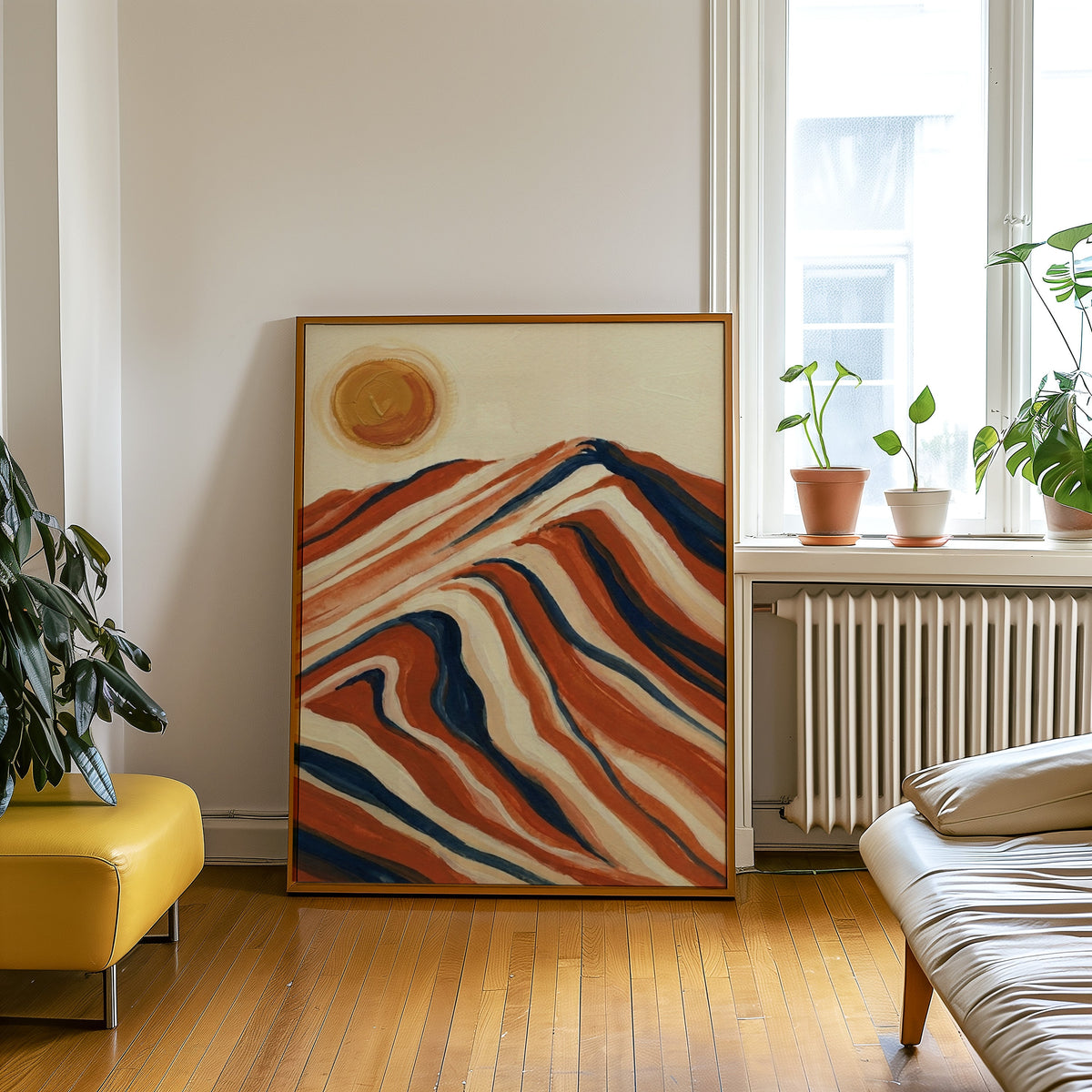 Wavy striped mountain print in an oak frame leaning beside a yellow leather bench