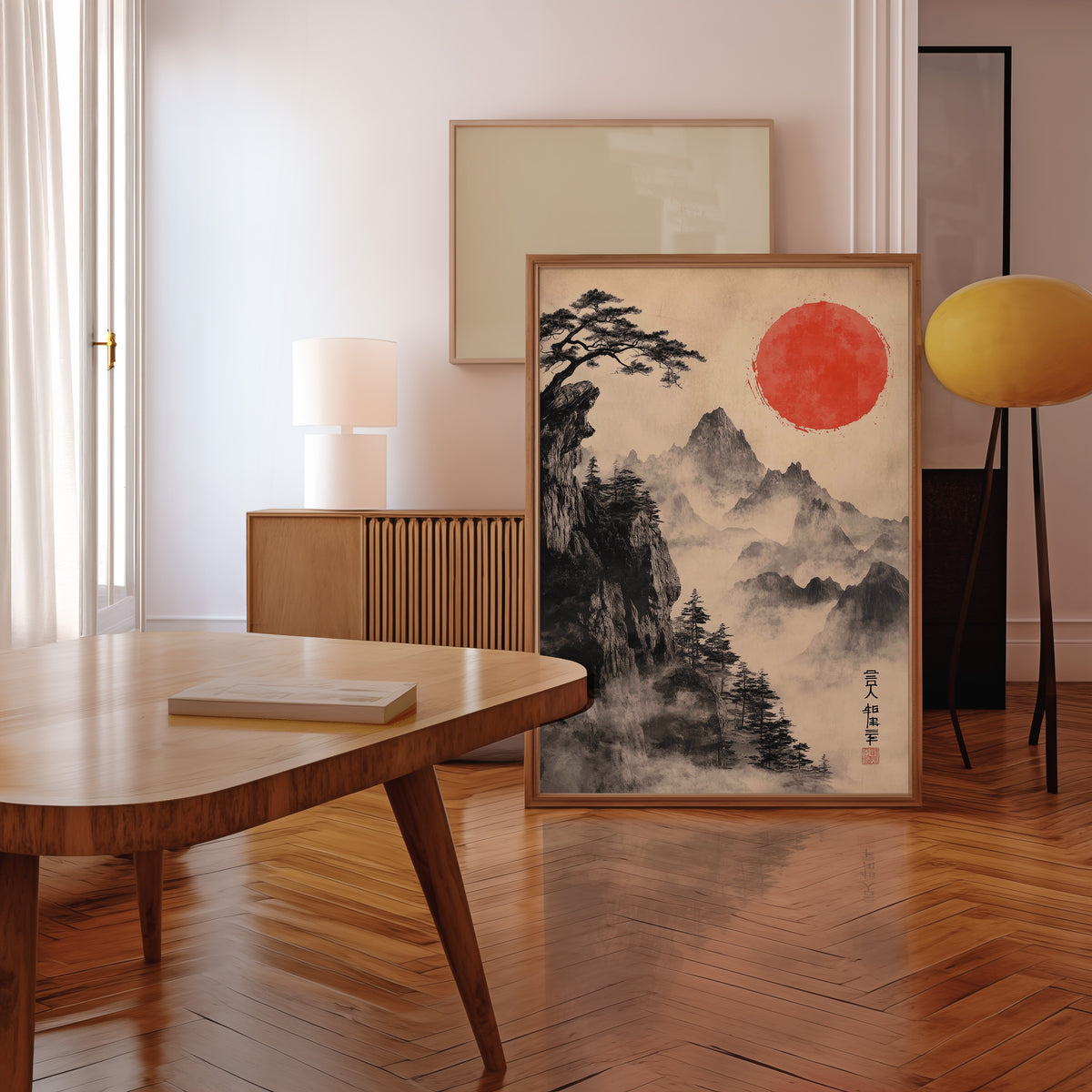 Sumi-e misty mountains and red sun print in a walnut frame leaning in a mid-century living room