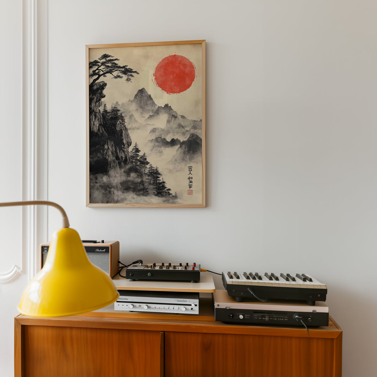 Sumi-e misty mountains and red sun print in an oak frame above a teak sideboard with vintage hi-fi