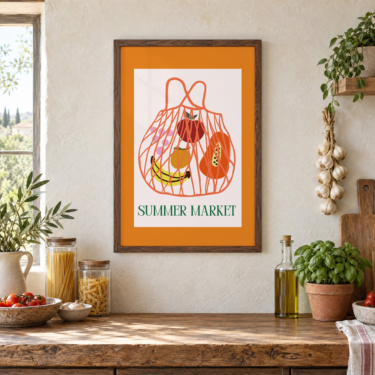 SUMMER MARKET fruit net bag print in a walnut frame above a rustic Italian pantry counter with pasta jars, garlic and tomatoes