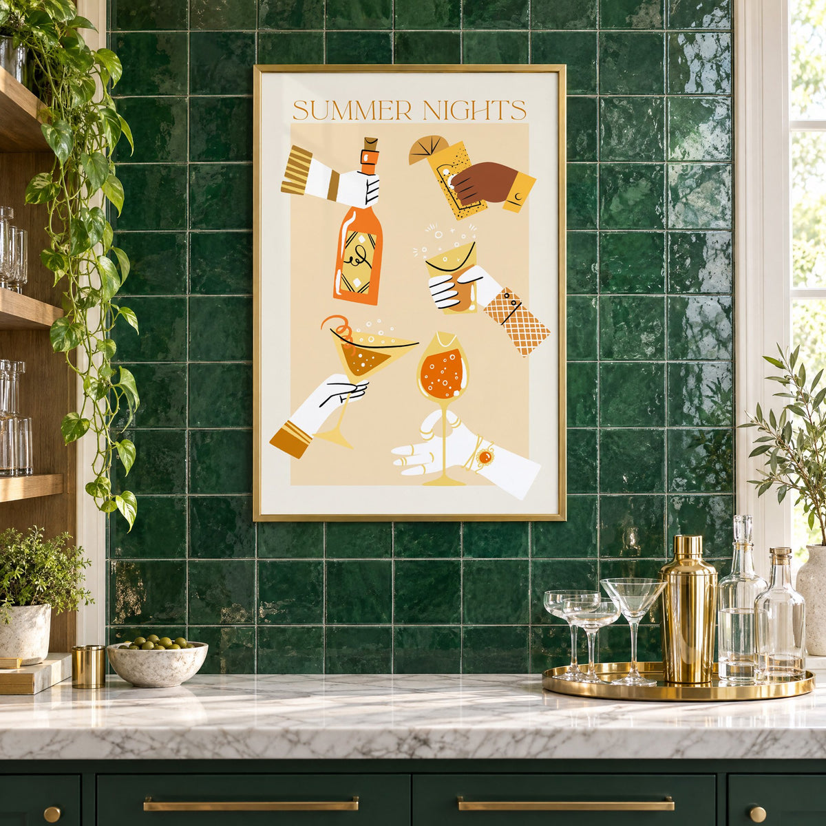 Summer Nights cocktail toast print in a brass frame on emerald green tiles above a home bar with coupe glasses