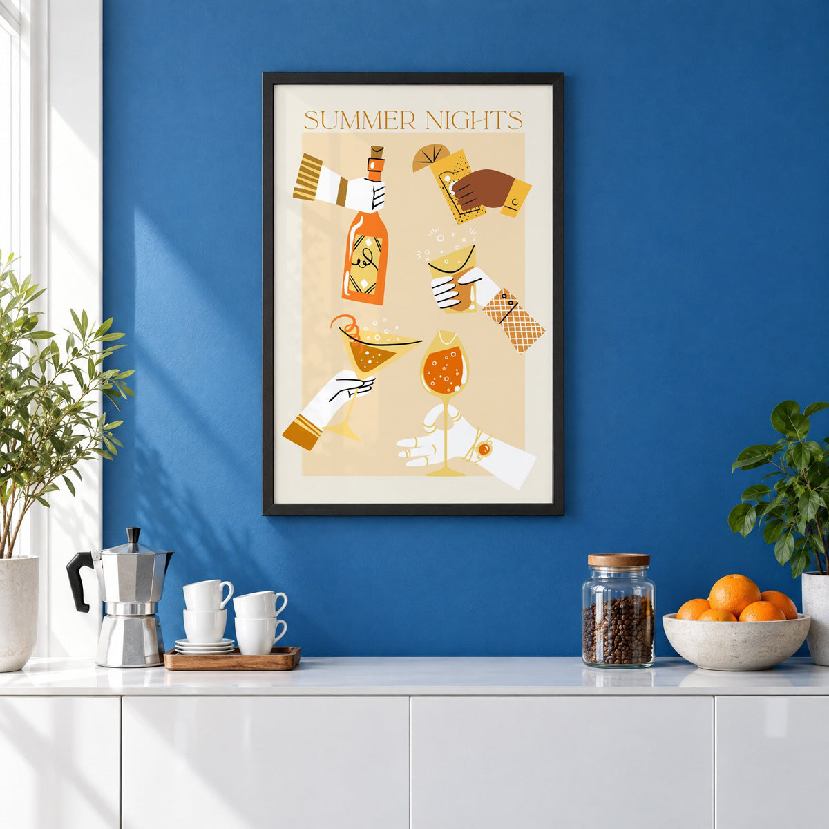 Summer Nights cocktail toast print in a black frame on a cobalt blue wall above a coffee station