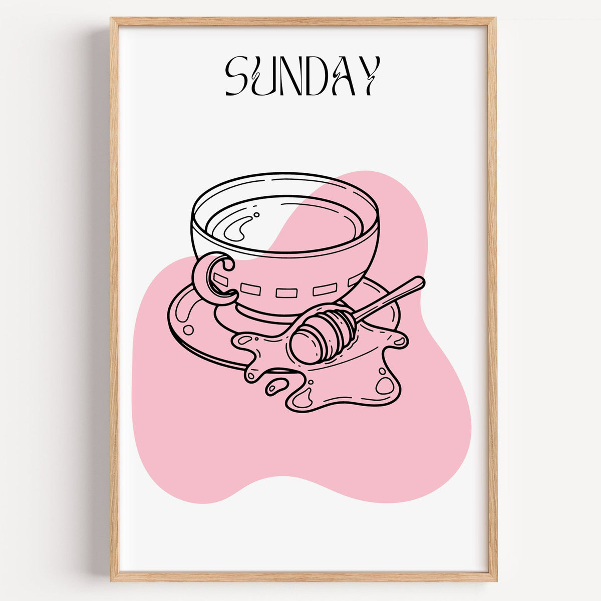 SUNDAY teacup and honey dipper line print in a light oak frame on a plain white wall