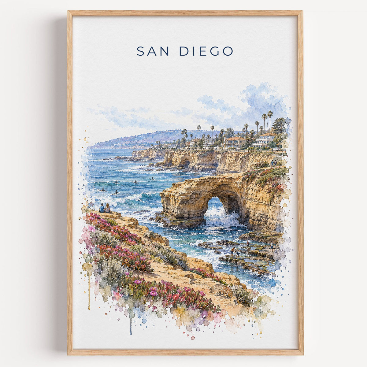 Sunset Cliffs San Diego watercolor print in a light oak frame on a plain white wall