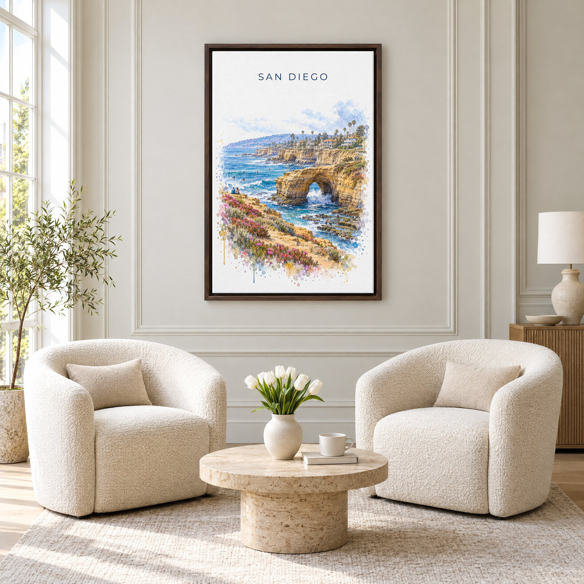 Sunset Cliffs San Diego watercolor print as an espresso floater canvas above two boucle armchairs in a hotel lounge