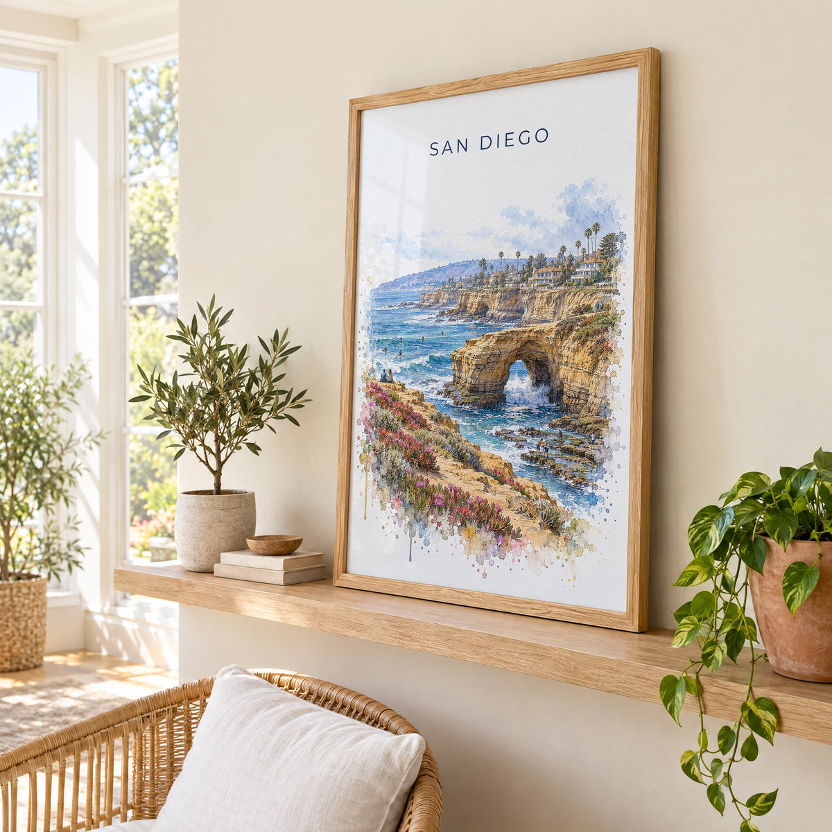 Sunset Cliffs San Diego watercolor print in an oak frame on a picture ledge in a sunlit sunroom