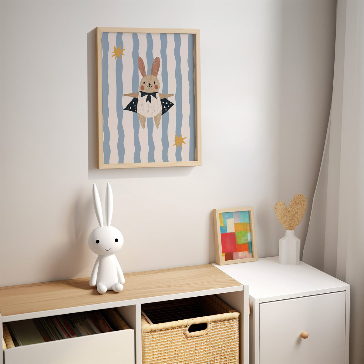 Superhero bunny star cape nursery print in an oak frame above a kids cubby shelf with a woven basket and bunny lamp