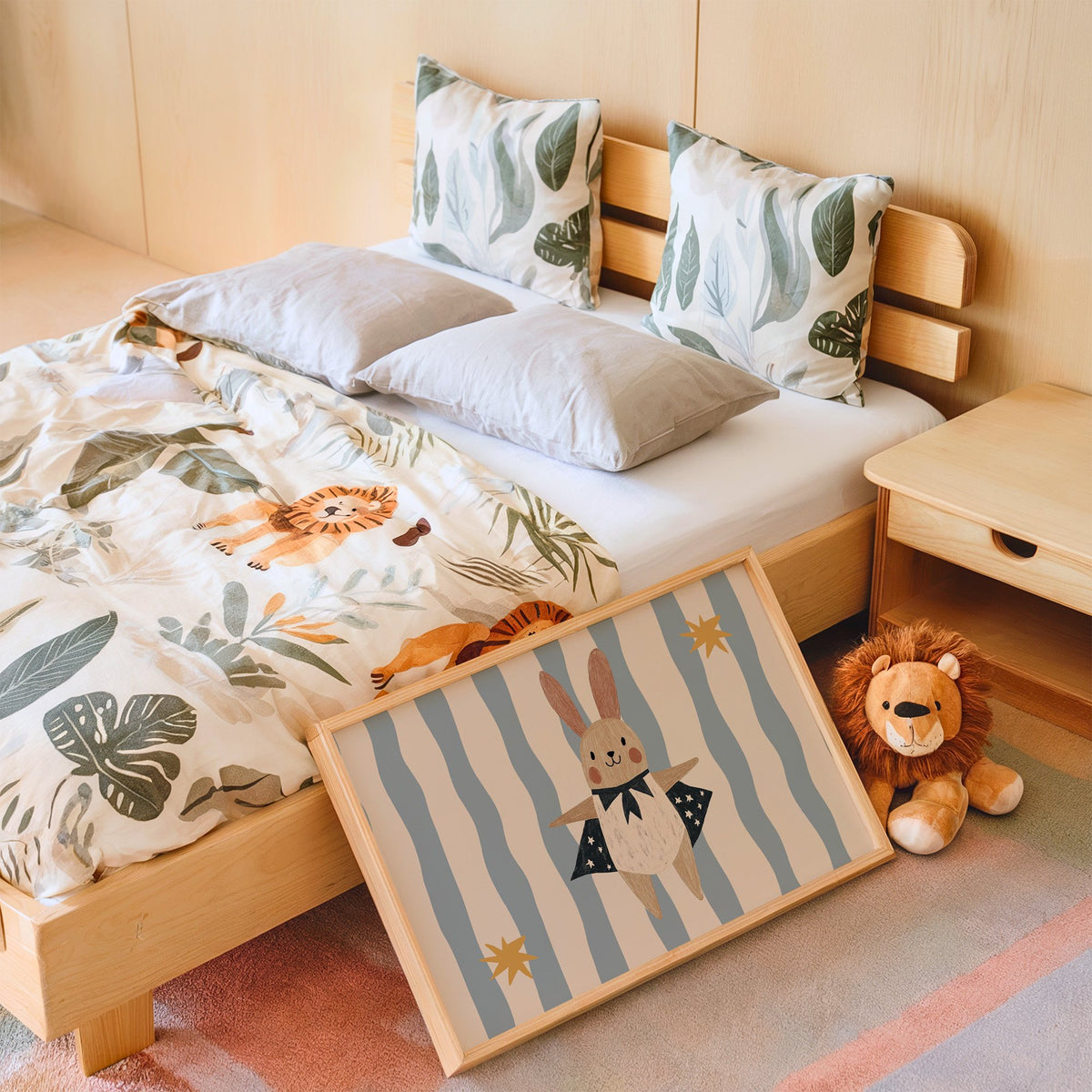 Landscape superhero bunny star cape nursery print in an oak frame leaning on a kids bed by a lion plush
