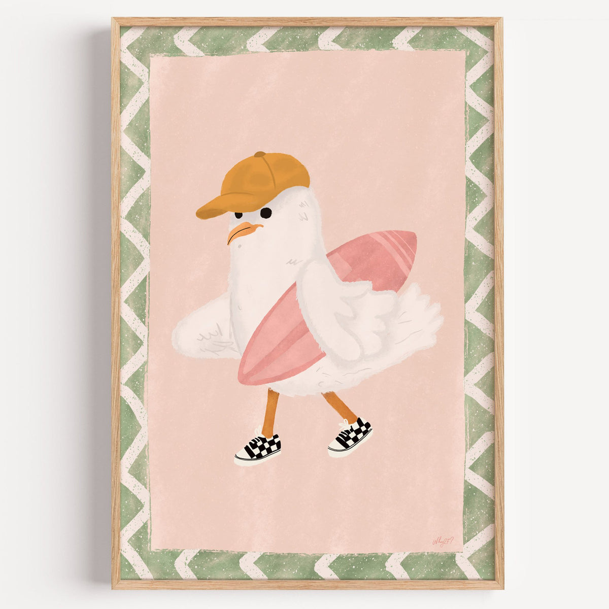 Surfer seagull with pink surfboard nursery print in a light oak frame on a plain white wall