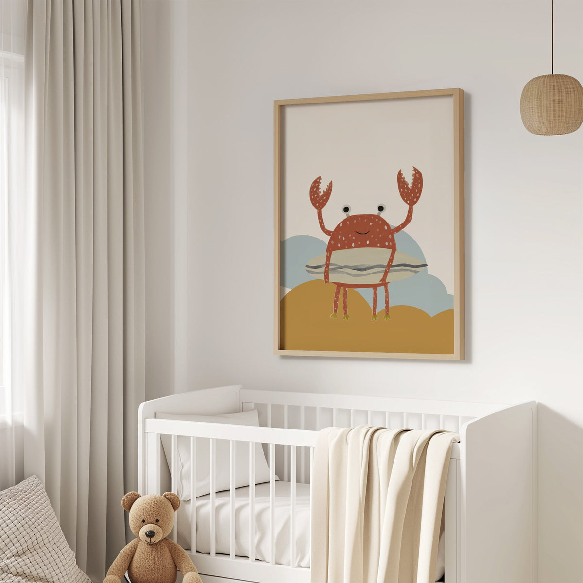 Surfing crab mustard hills nursery print in an oak frame above a white crib with a teddy bear