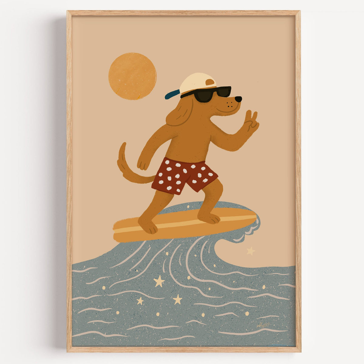 Surfing dog with peace sign nursery print in a light oak frame on a plain white wall
