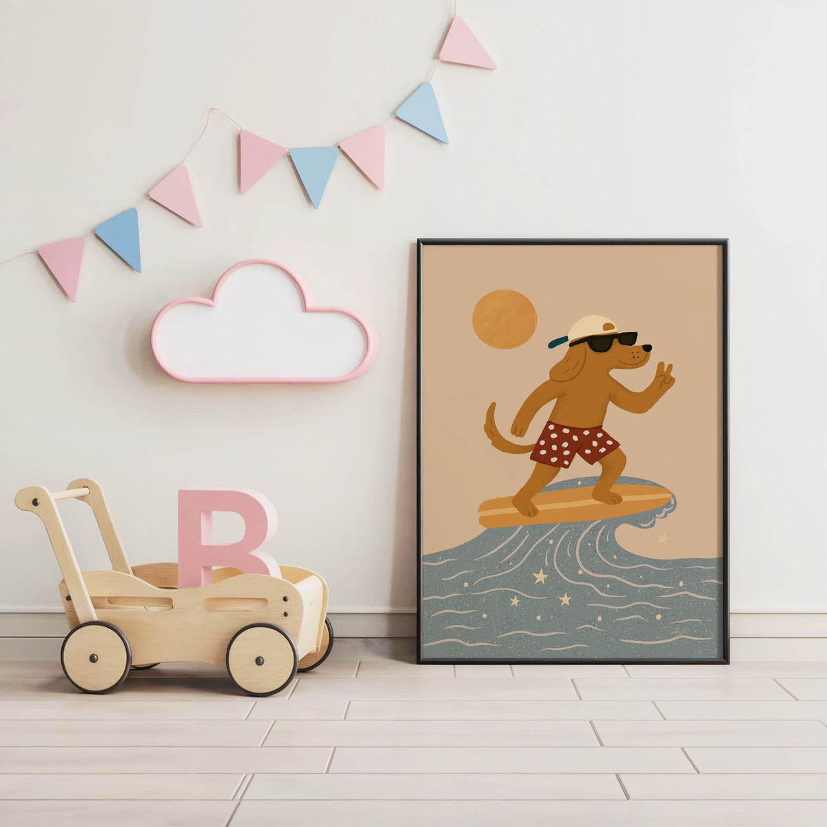 Surfing dog with peace sign nursery print in a black frame under pastel bunting by a wooden baby walker