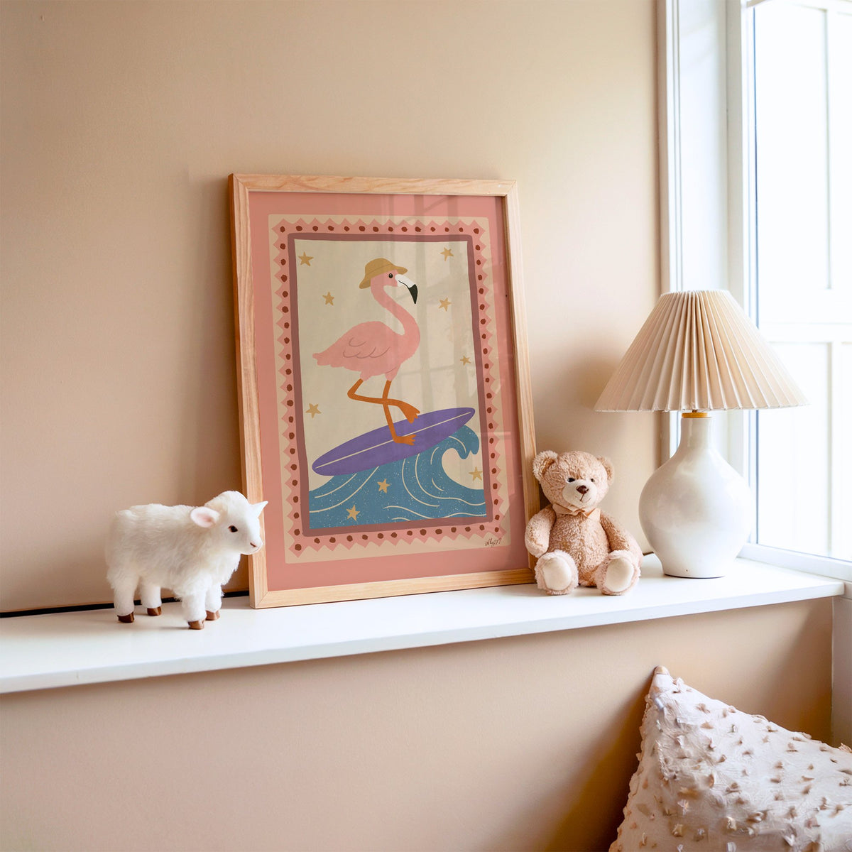 Flamingo on purple surfboard nursery print in an oak frame on a window ledge with a toy lamb and teddy