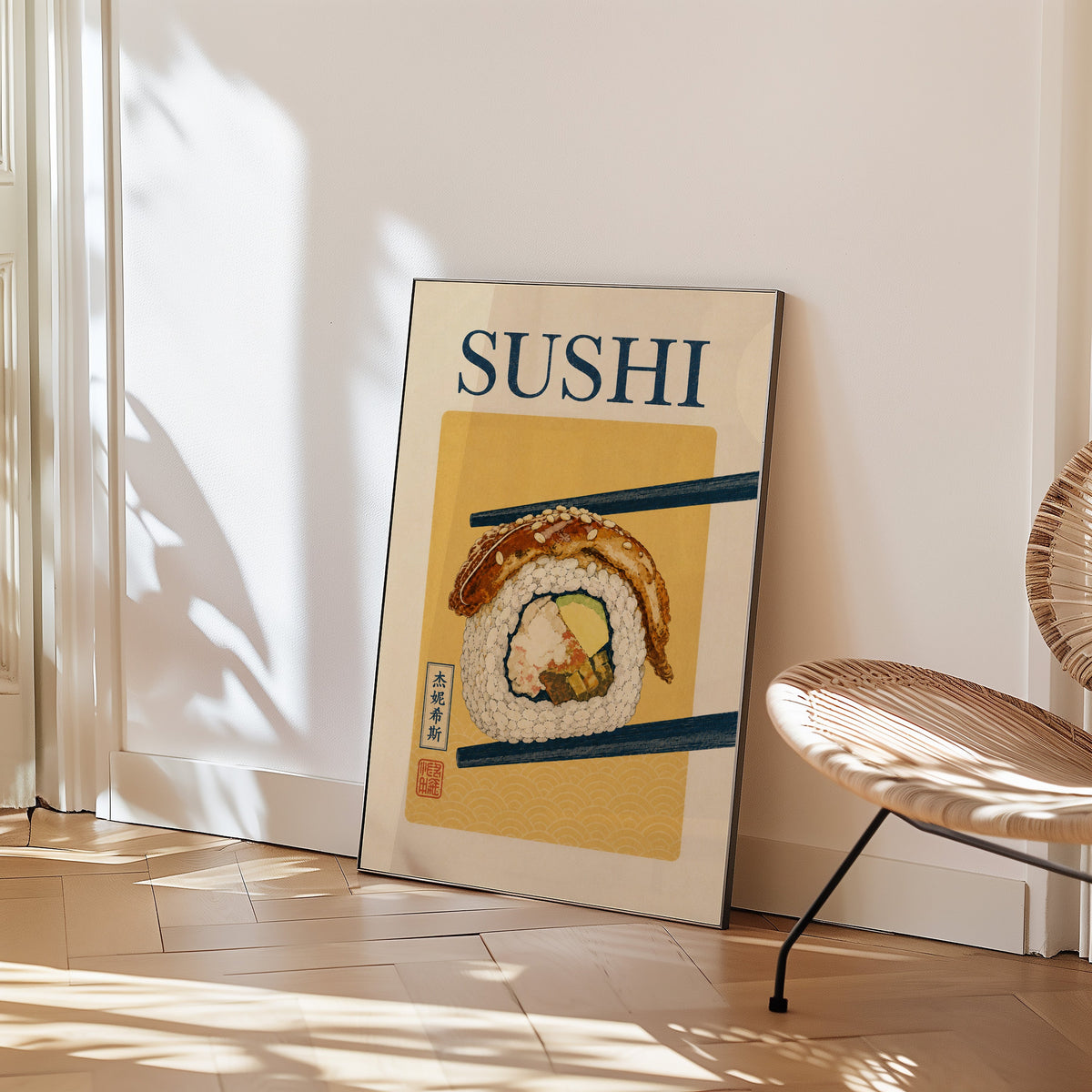 sushi roll in navy chopsticks print in a black frame leaning on a herringbone floor beside a woven rattan chair