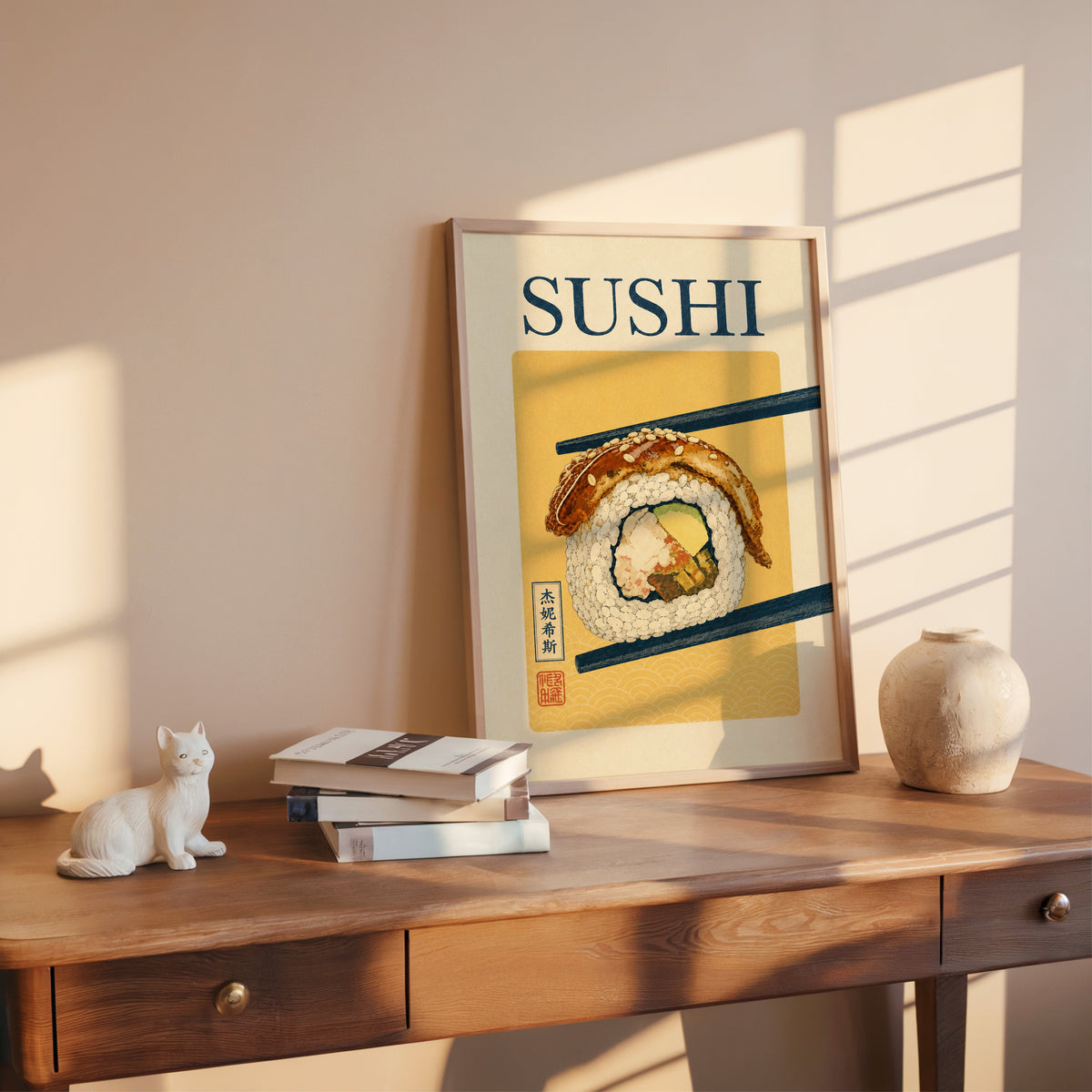 sushi roll in navy chopsticks print shown in a rose gold frame leaning on a wooden writing desk with books