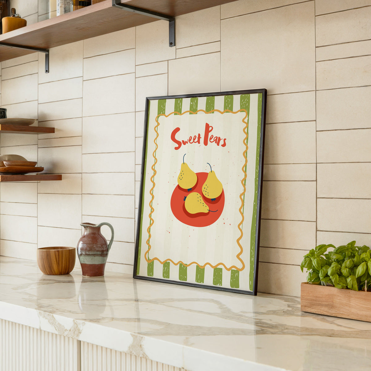 Sweet Pears print in a black frame leaning on a marble counter in a tiled kitchen