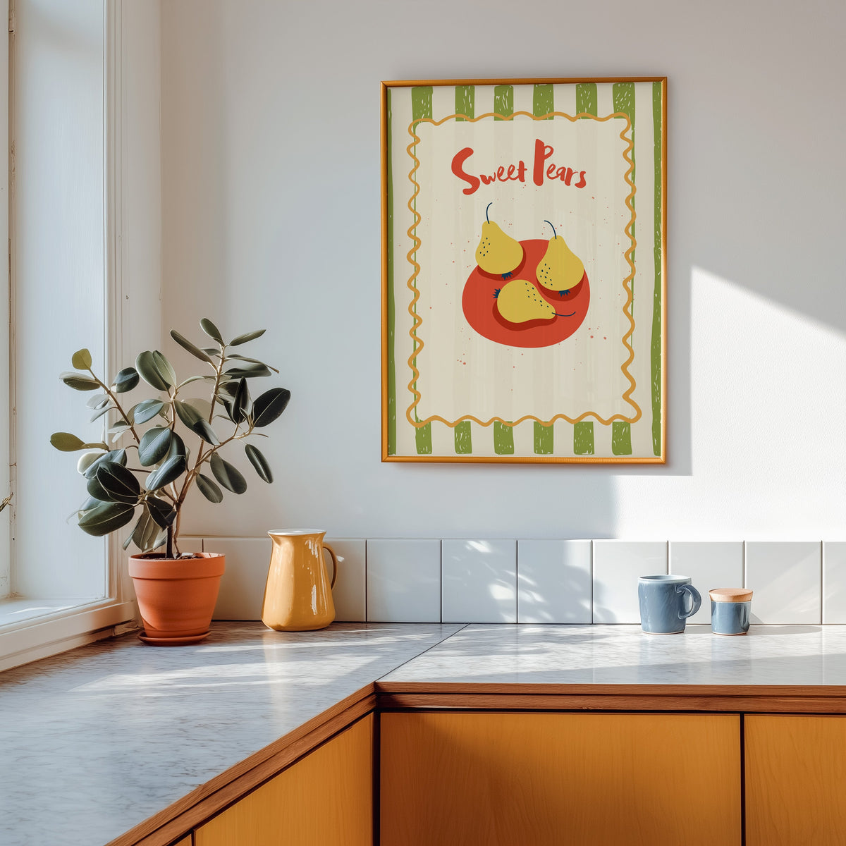 Sweet Pears print shown in a gold frame above a marble counter in a tan kitchen