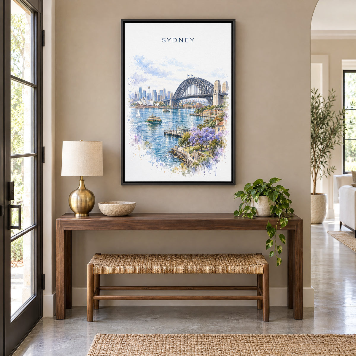 Sydney Harbour Bridge watercolor print as a black floater canvas above a walnut console and woven bench in an entryway