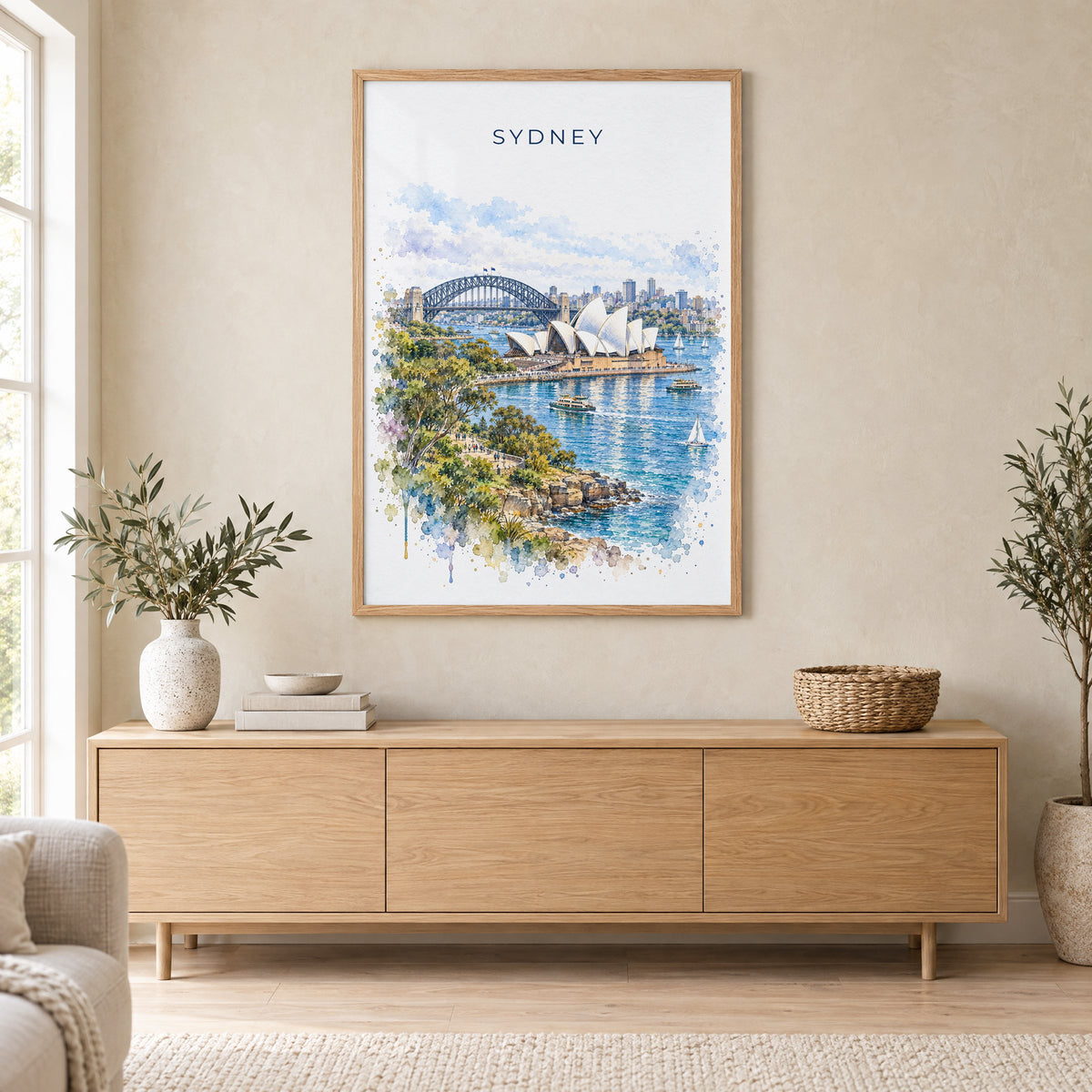 Sydney watercolor print in an oak frame above a light wood sideboard in a Scandinavian living room