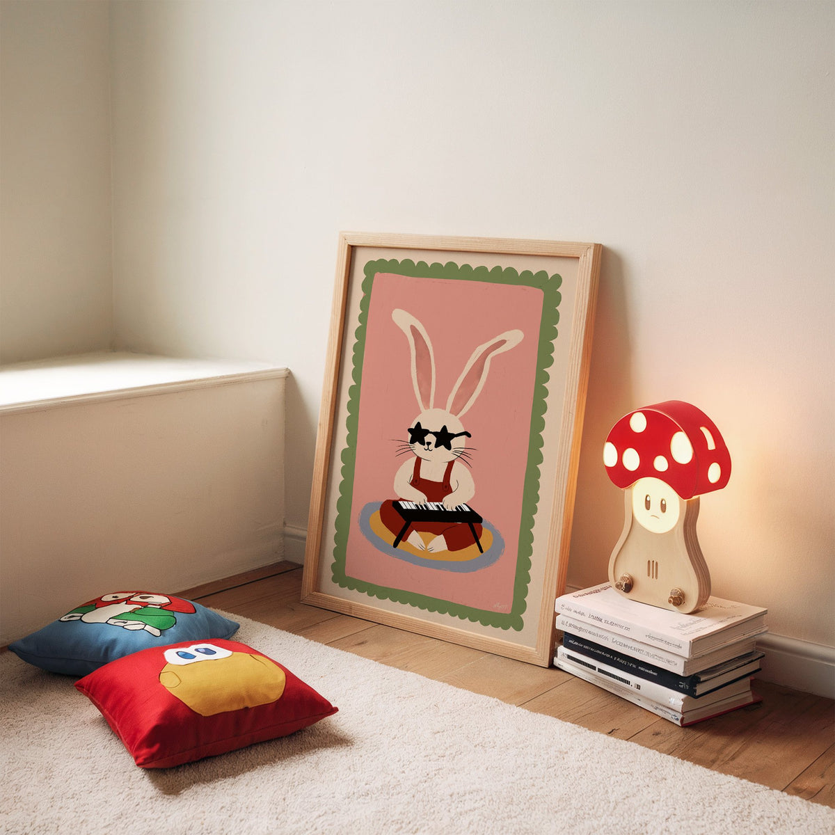 Bunny playing keyboard in star glasses nursery print in an oak frame leaning on a rug beside a mushroom lamp and floor