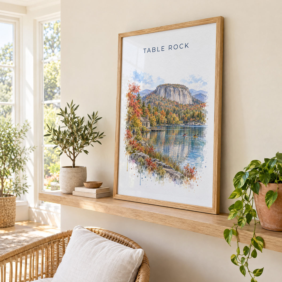 Table Rock State Park watercolor print in an oak frame on a picture ledge in a sunlit sunroom