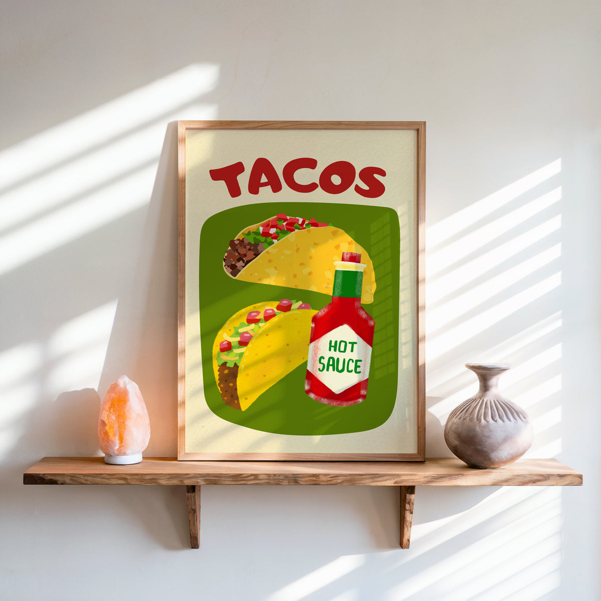 Tacos and hot sauce print in an oak frame on a live-edge shelf beside a salt lamp
