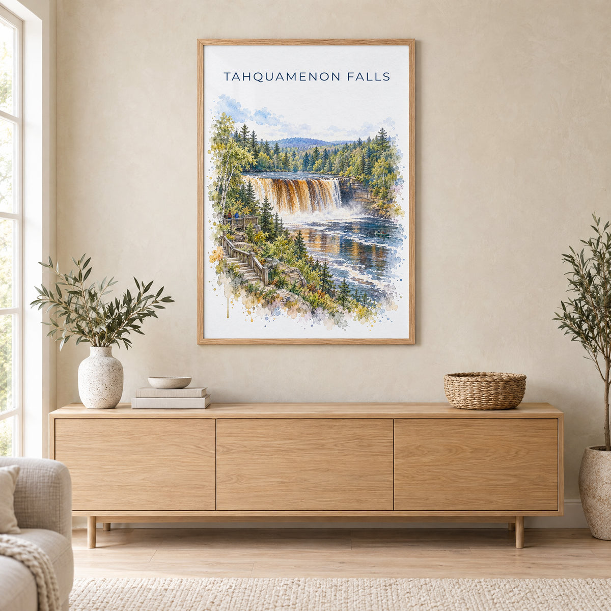 Tahquamenon Falls watercolor print in an oak frame above a light wood sideboard in a Scandinavian living room