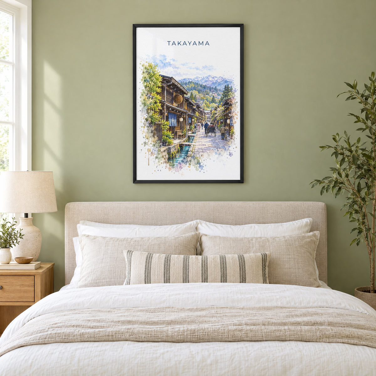 Takayama watercolor print in a black frame above an upholstered headboard in a sage green bedroom