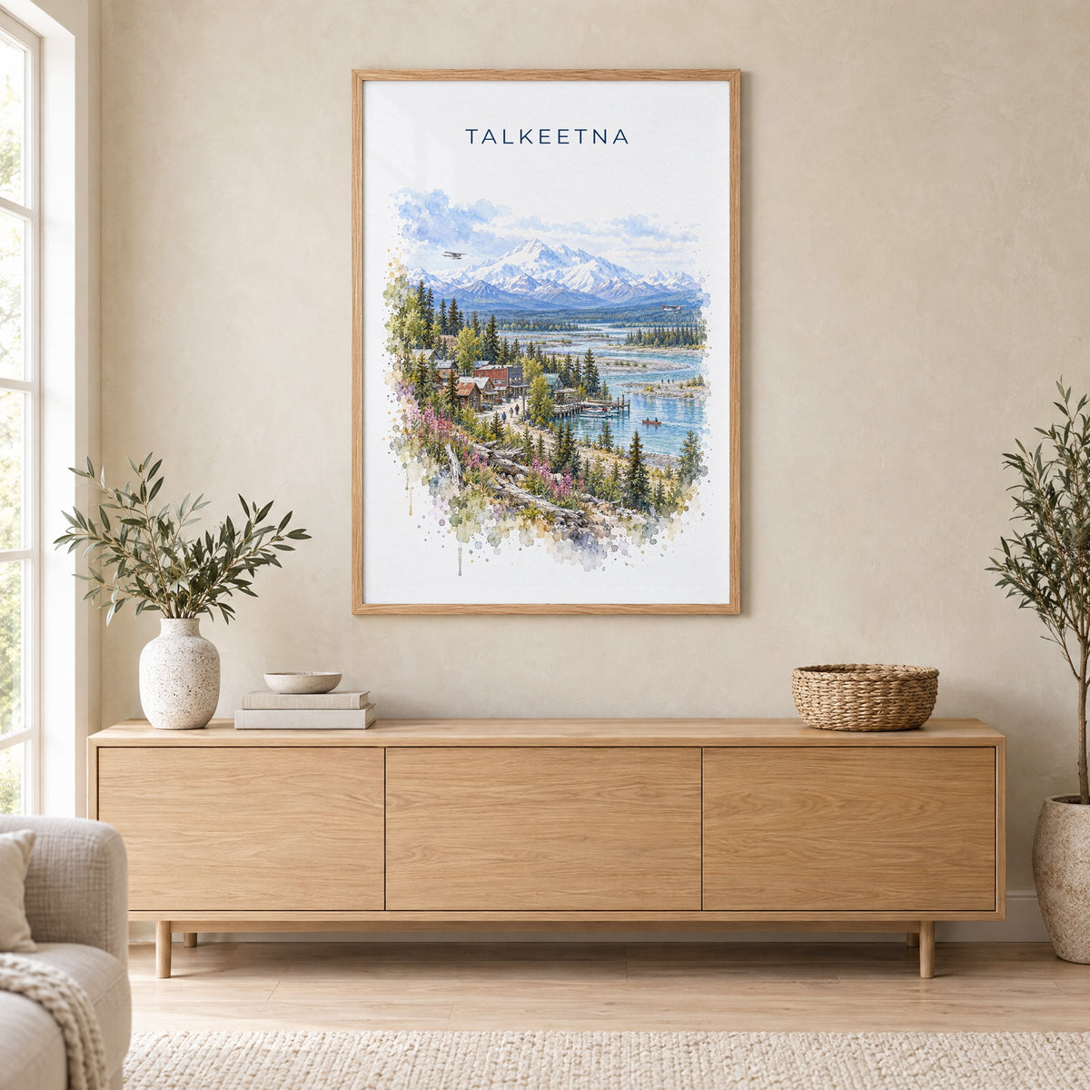 Talkeetna, Alaska watercolor print in an oak frame above a light wood sideboard in a Scandinavian living room
