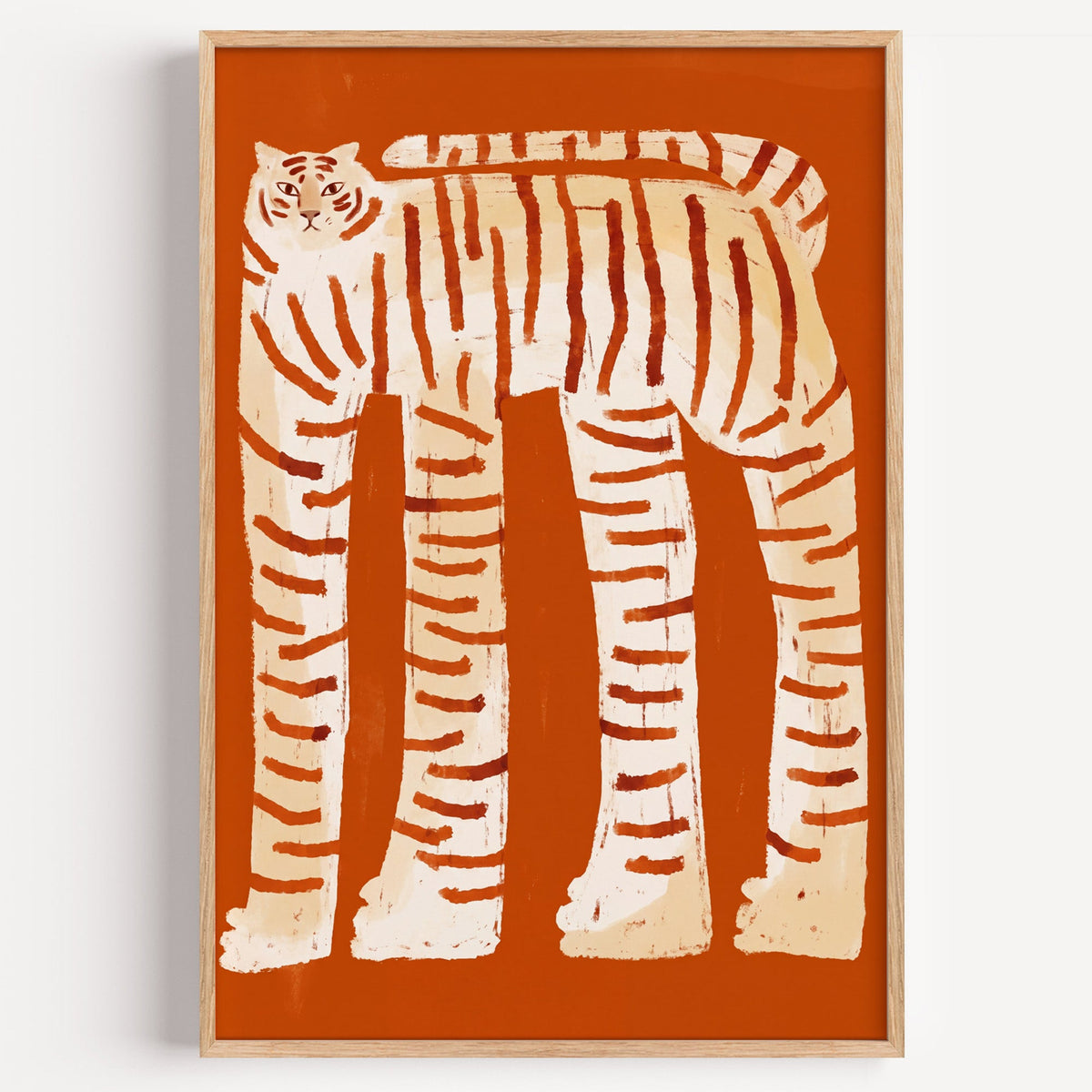 Tall striped tiger print in a light oak frame on a plain white wall