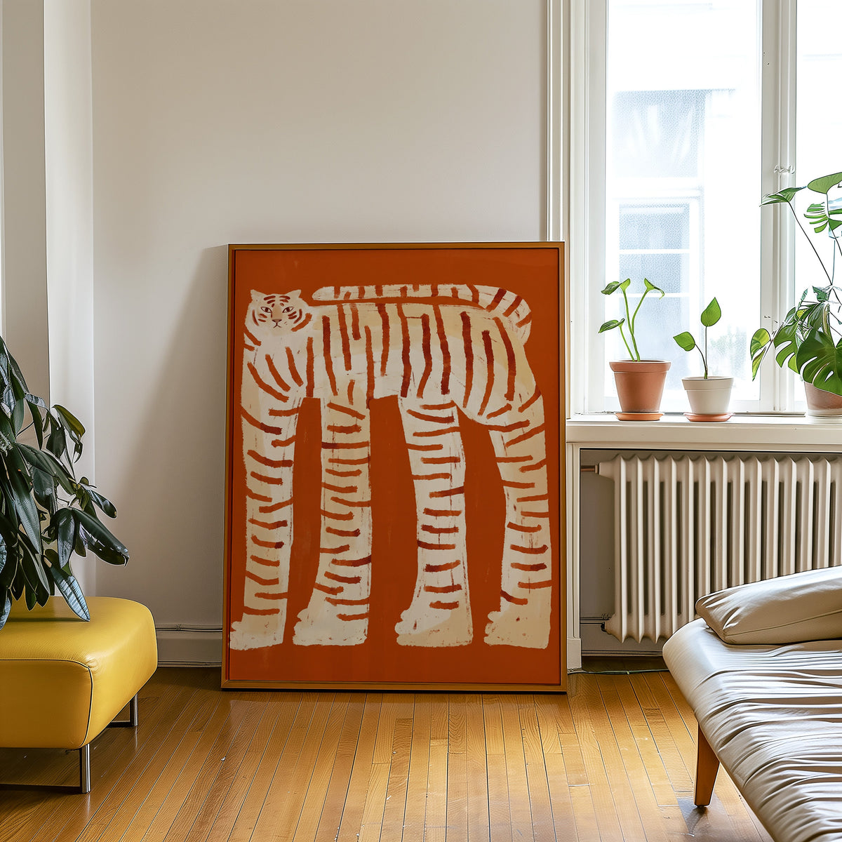 Burnt orange tiger print in an oak frame leaning beside a yellow leather bench