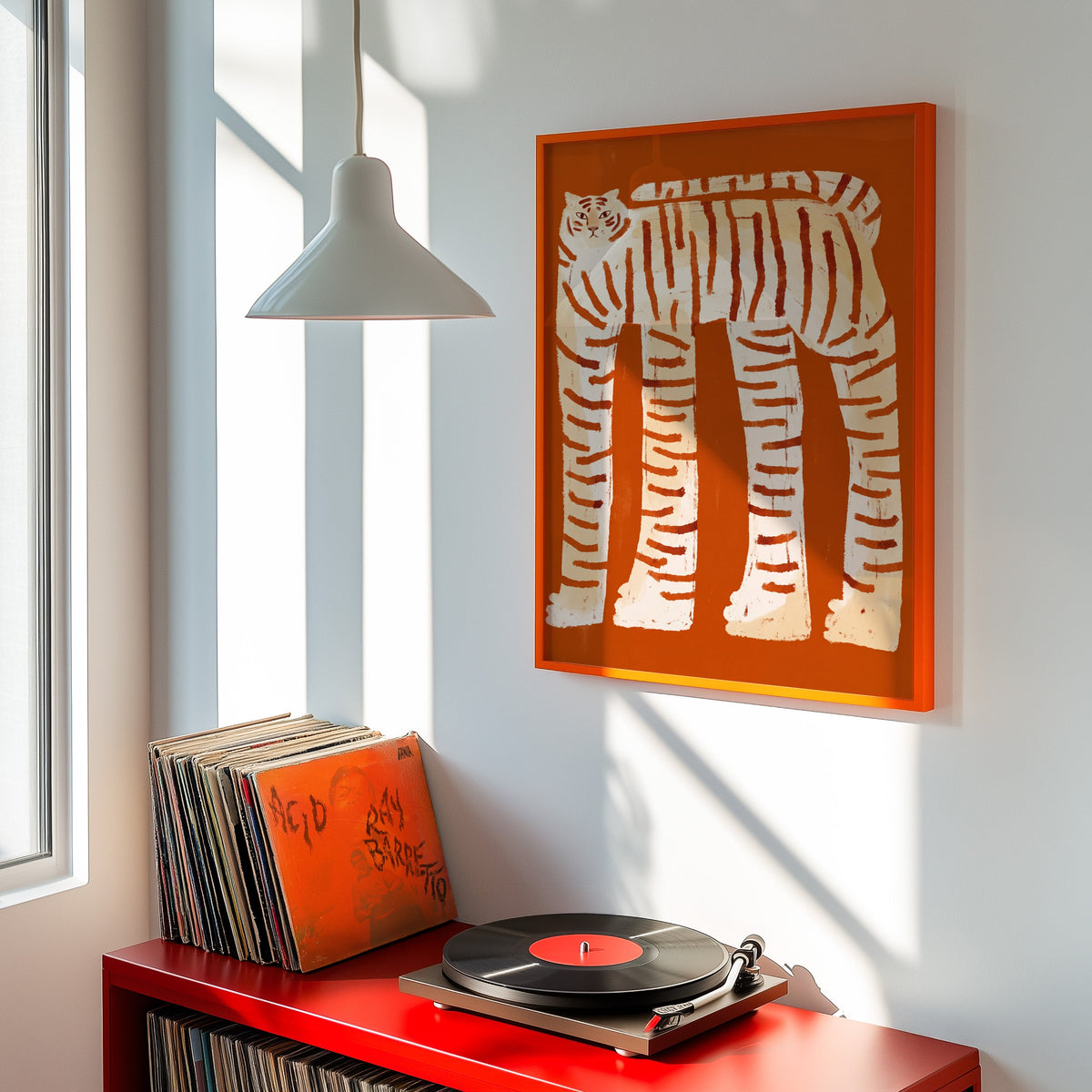 Rust and cream tiger print shown in an orange frame above a red record cabinet and turntable