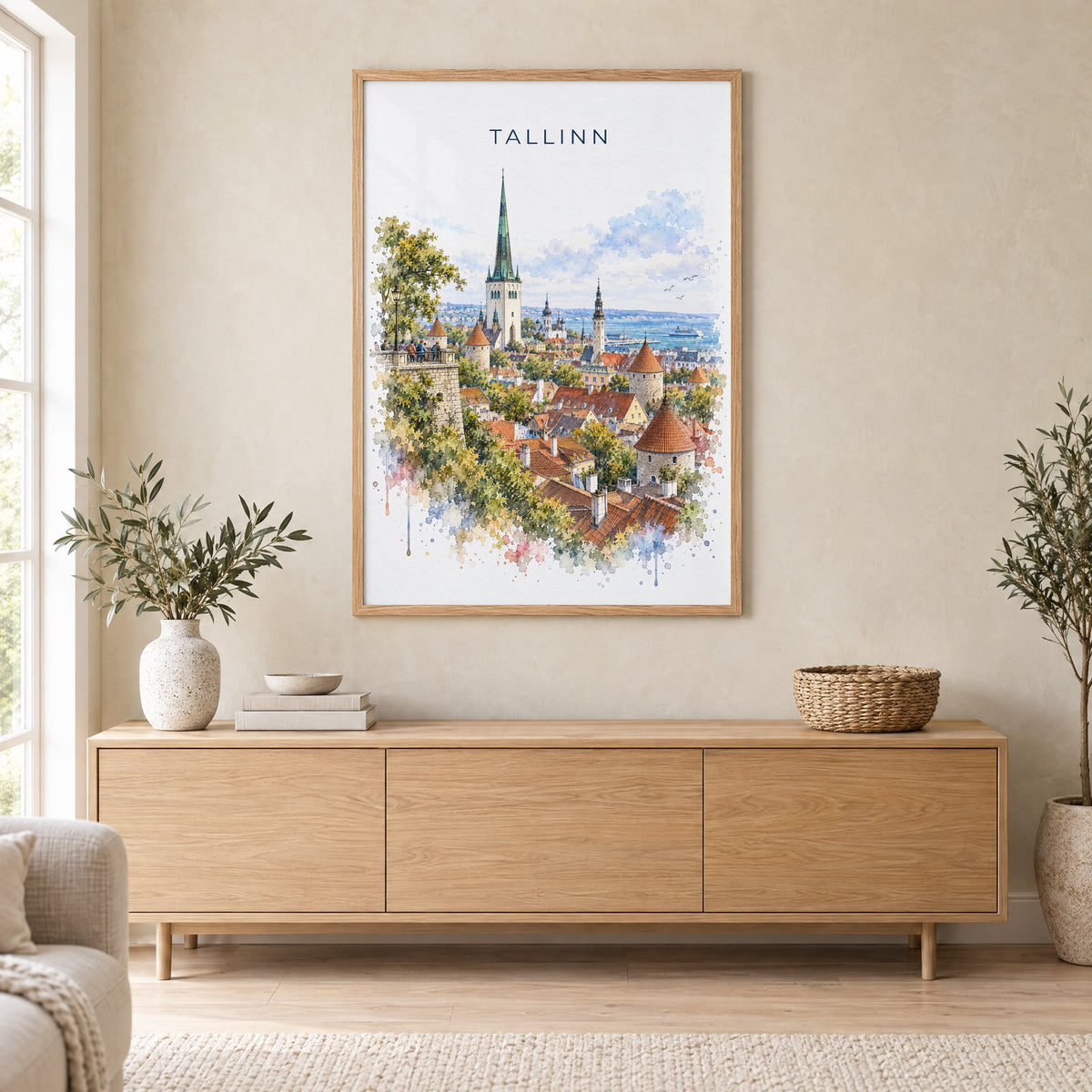 Tallinn watercolor print in an oak frame above a light wood sideboard in a Scandinavian living room