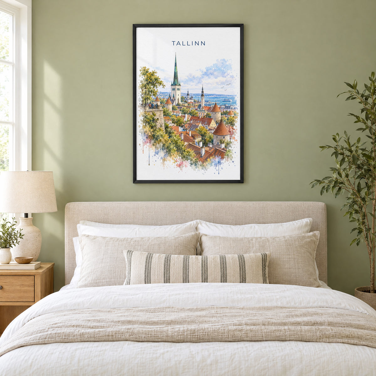 Tallinn watercolor print in a black frame above an upholstered headboard in a sage green bedroom