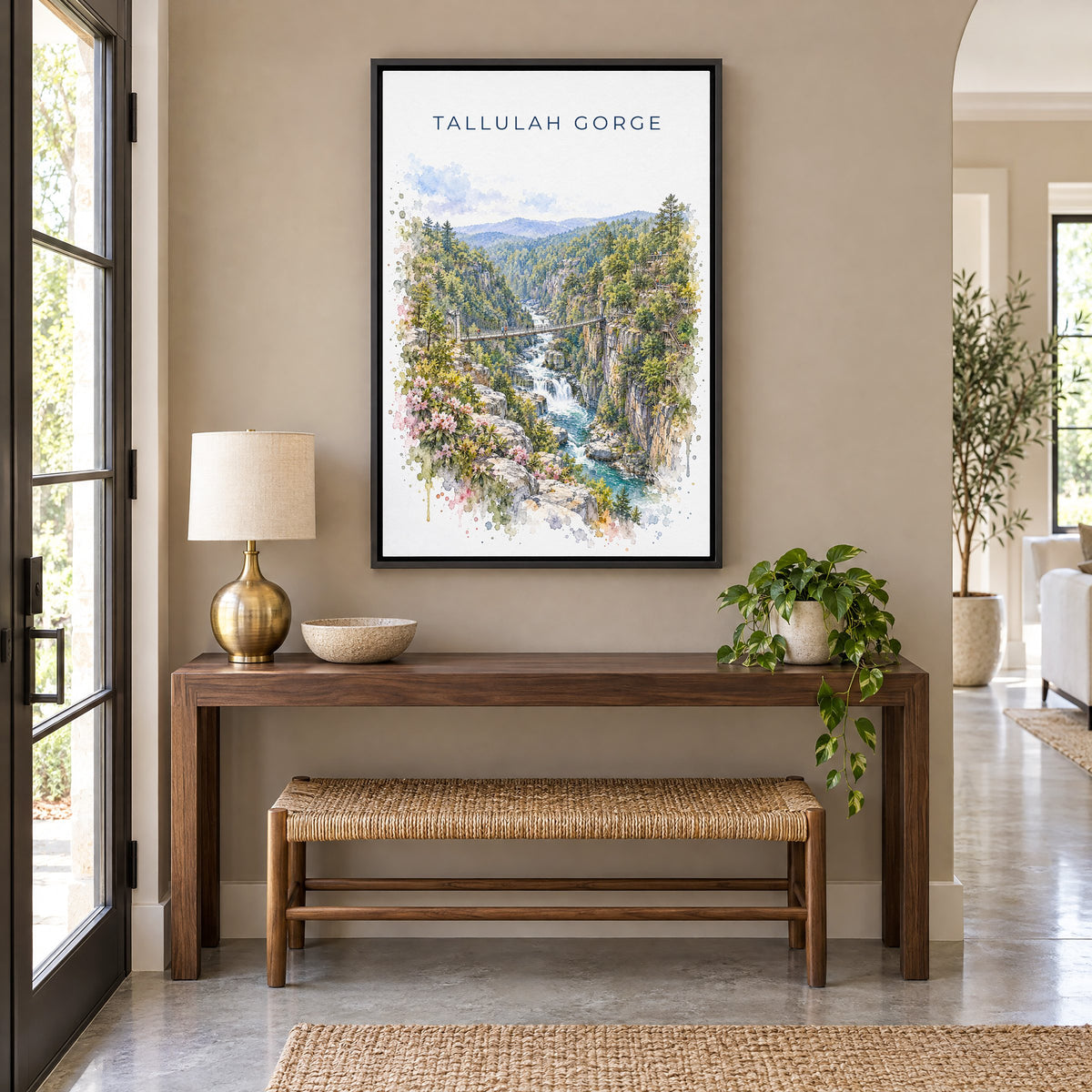 Tallulah Gorge watercolor print as a black floater canvas above a walnut console and woven bench in an entryway