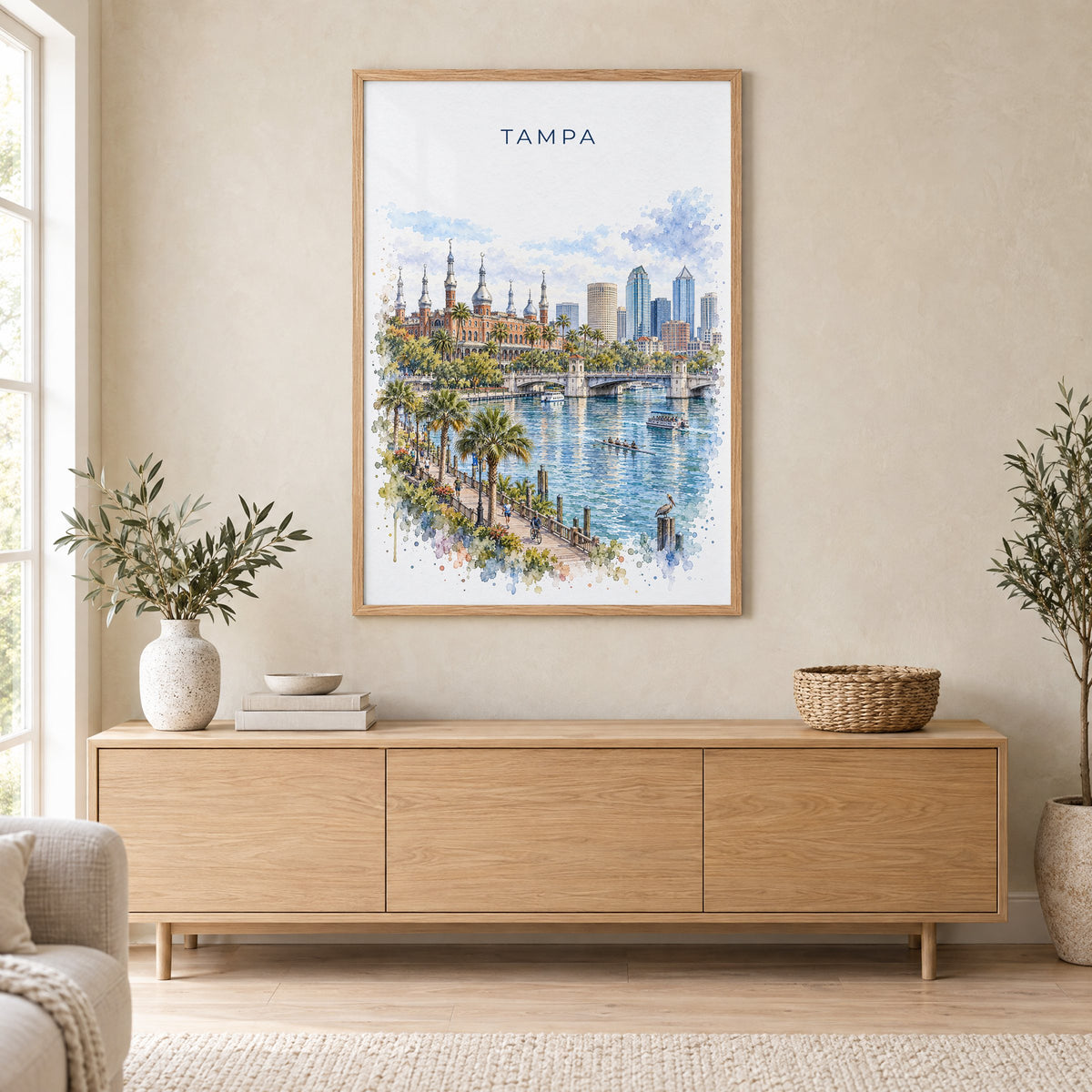 Tampa watercolor print in an oak frame above a light wood sideboard in a Scandinavian living room