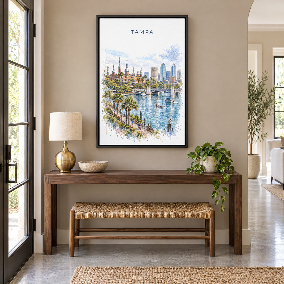 Tampa watercolor print as a black floater canvas above a walnut console and woven bench in an entryway